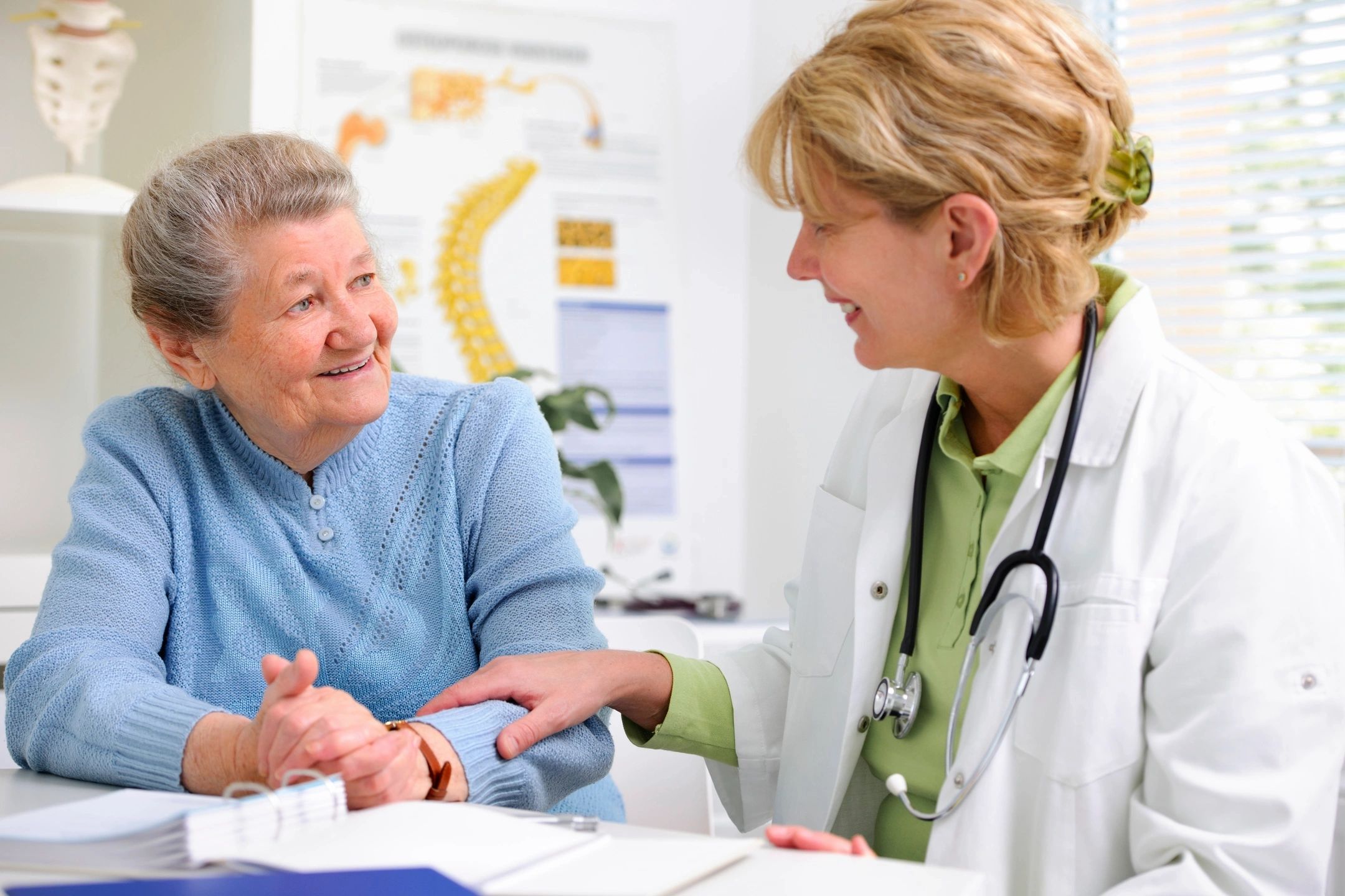 Doctor checking senior patient's pulse during a Heart & Vascular Screening